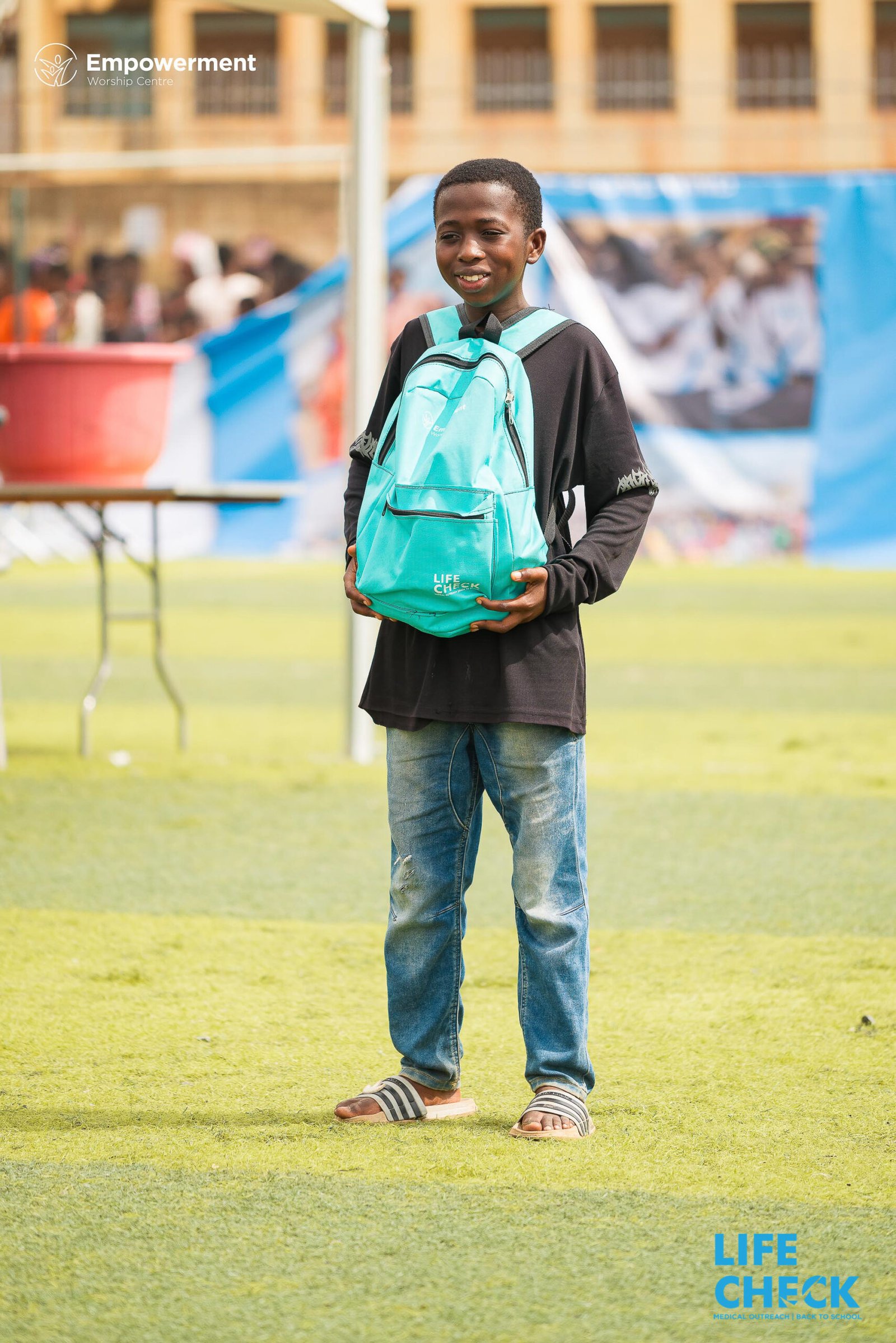 A child with a new LifeCheck backpack at LifeCheck 2025