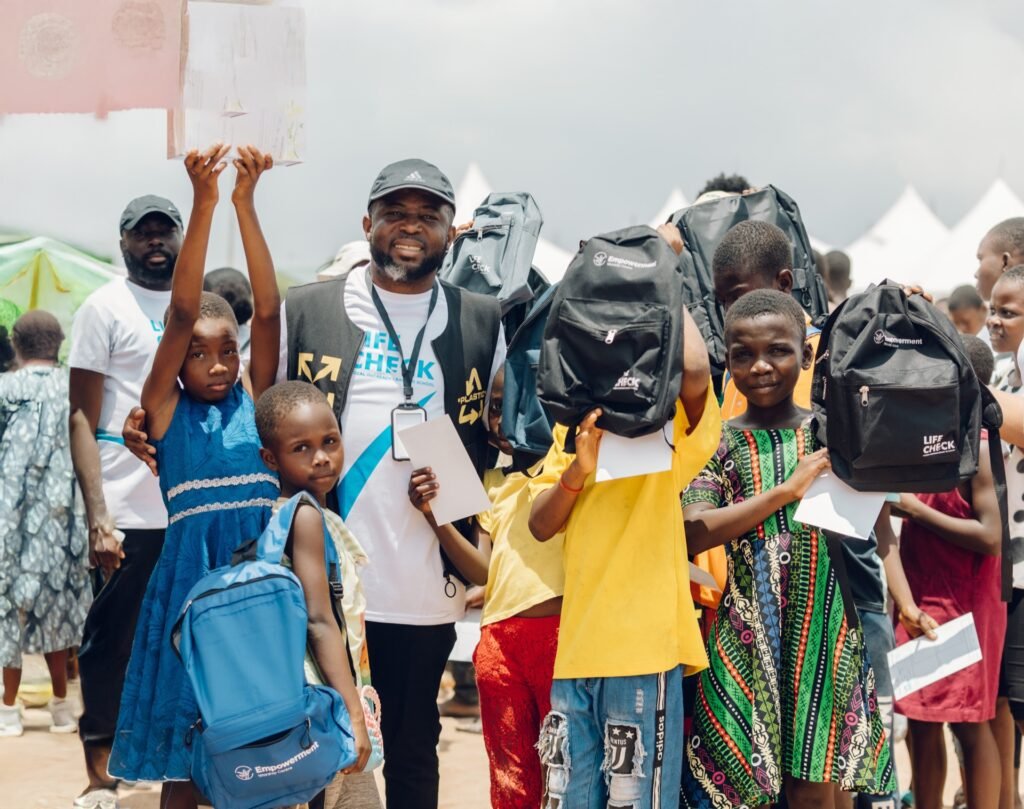 Children holding up new LifeCheck backpacks