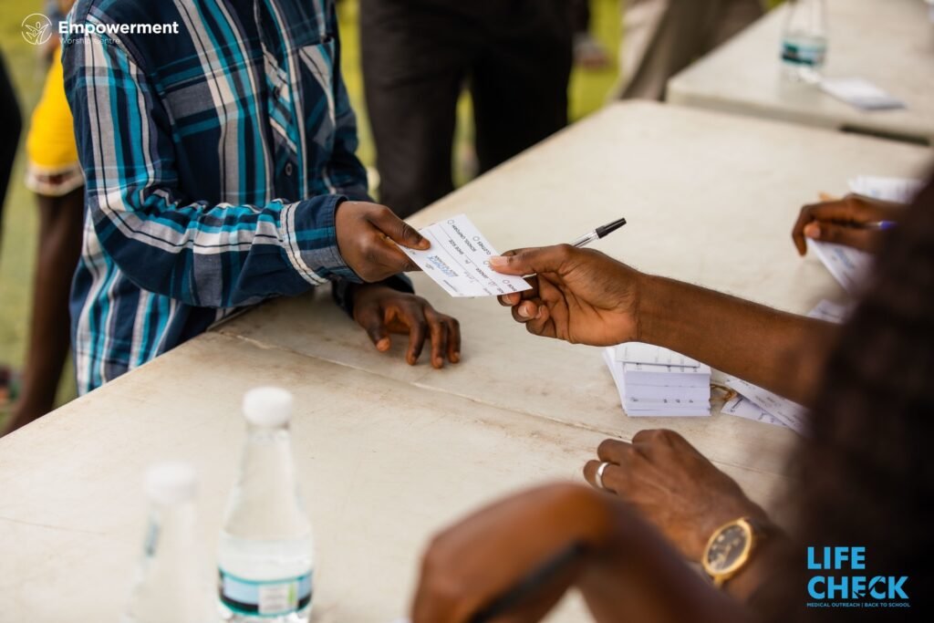 Hands exchanging a filled LifeCheck registration card