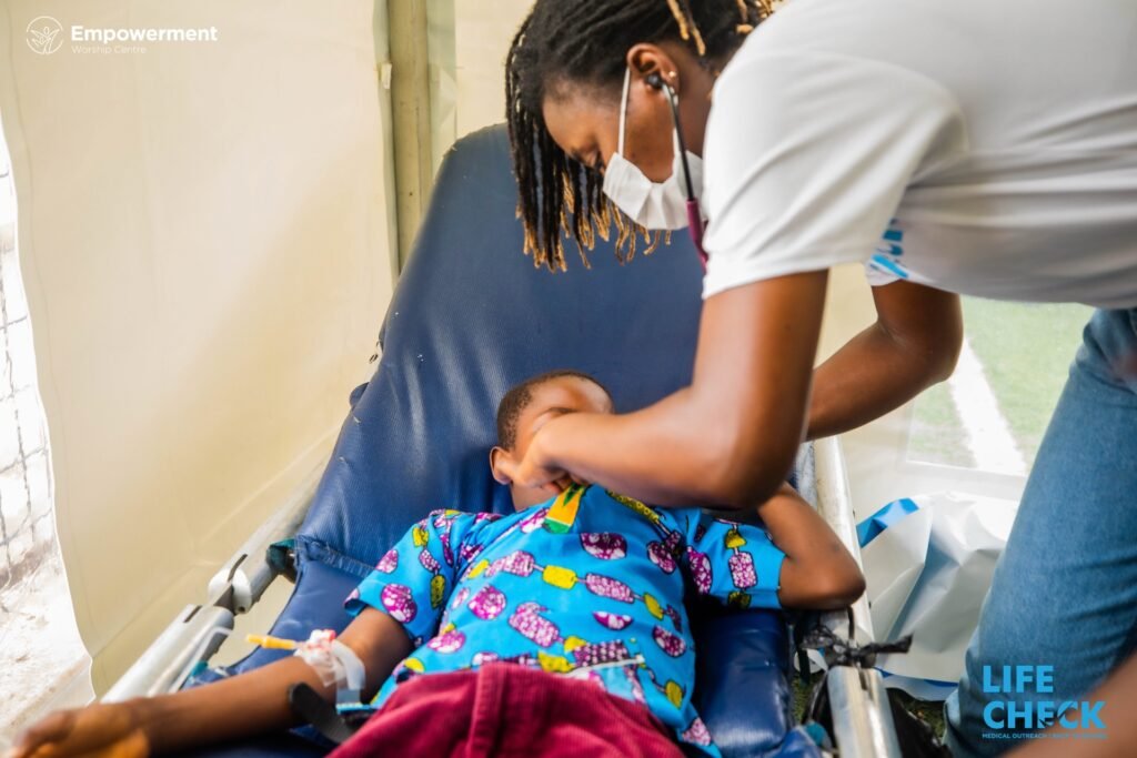 A nurse listening to a child's chest with a stethoscope